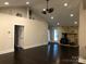 Bright living room with dark hardwood floors, wood burning stove and ceiling fan at 12136 Renee Ford Rd, Stanfield, NC 28163