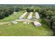 Aerial view of a large property with multiple chicken houses and outbuildings at 12136 Renee Ford Rd, Stanfield, NC 28163