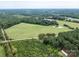 Aerial view of expansive land with pond and road at 12136 Renee Ford Rd, Stanfield, NC 28163