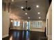 Open living room with hardwood floors, high ceilings, and plantation shutters at 12136 Renee Ford Rd, Stanfield, NC 28163