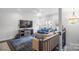 Spacious living room with comfortable seating, a large TV, and a ceiling fan at 12119 Brooklyn Ave, Charlotte, NC 28204