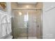 Clean shower with tile surround and glass door at 12119 Brooklyn Ave, Charlotte, NC 28204