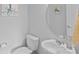 Clean and modern bathroom with a round mirror and white vanity at 12119 Brooklyn Ave, Charlotte, NC 28204