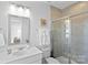 Modern bathroom with a large shower and white vanity at 12119 Brooklyn Ave, Charlotte, NC 28204