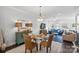 Bright dining area with glass table and wicker chairs, open to living room at 12119 Brooklyn Ave, Charlotte, NC 28204
