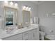 Modern double vanity bathroom with neutral colors and a view of the bedroom at 12119 Brooklyn Ave, Charlotte, NC 28204