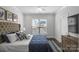 Bright bedroom with a large bed, neutral decor, and a view from the window at 12119 Brooklyn Ave, Charlotte, NC 28204