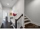 Clean and bright hallway with dark hardwood floors and stairs at 12119 Brooklyn Ave, Charlotte, NC 28204