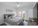 Comfortable bedroom with a queen-size bed and access to a private balcony at 12119 Brooklyn Ave, Charlotte, NC 28204