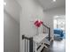 Bright hallway with white table, dark hardwood floors, and stairs leading upstairs at 12119 Brooklyn Ave, Charlotte, NC 28204
