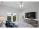 Spacious bedroom with a queen-size bed and a large TV at 12119 Brooklyn Ave, Charlotte, NC 28204