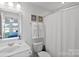 Clean bathroom with shower/tub combo and updated fixtures at 12119 Brooklyn Ave, Charlotte, NC 28204