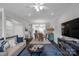 Spacious living room features a comfortable sofa and a large TV at 12119 Brooklyn Ave, Charlotte, NC 28204