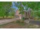 Brick home with a deck, patio, and pond view at 15610 Youngblood Rd, Charlotte, NC 28278