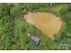 Aerial view of a house and private pond at 15610 Youngblood Rd, Charlotte, NC 28278