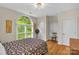 Spacious bedroom with a large window, hardwood floors, and a walk-in closet at 15610 Youngblood Rd, Charlotte, NC 28278