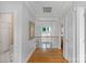 Bright hallway with hardwood floors, a view of the backyard, and an open railing at 15610 Youngblood Rd, Charlotte, NC 28278