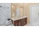 Elegant bathroom with double vanity, marble tile, and large mirror at 15610 Youngblood Rd, Charlotte, NC 28278