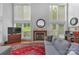 Spacious living room with hardwood floors, fireplace, large windows, and sectional sofa at 15610 Youngblood Rd, Charlotte, NC 28278