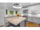Modern kitchen with granite island, white cabinets, and stainless steel appliances at 15610 Youngblood Rd, Charlotte, NC 28278