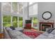 Spacious living room with hardwood floors, fireplace, large windows, and sectional sofa at 15610 Youngblood Rd, Charlotte, NC 28278