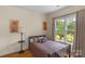 Cozy bedroom with a double bed and a view of a pond and trees at 15610 Youngblood Rd, Charlotte, NC 28278