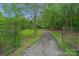 Long driveway with wrought iron gates leading to home at 15610 Youngblood Rd, Charlotte, NC 28278