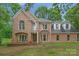 Brick house with a two-car garage and landscaped yard at 15610 Youngblood Rd, Charlotte, NC 28278