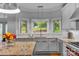 Modern kitchen with granite countertops, white cabinets, and corner window at 15610 Youngblood Rd, Charlotte, NC 28278