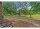 Brick patio with seating, overlooking pond and trees at 15610 Youngblood Rd, Charlotte, NC 28278