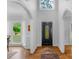 Bright entryway with hardwood floors, black front door, and arched hallways at 15610 Youngblood Rd, Charlotte, NC 28278