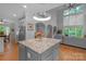 Modern kitchen with large granite island and stainless steel appliances at 15610 Youngblood Rd, Charlotte, NC 28278
