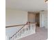 Upstairs hallway with wood railing and carpet at 1813 Augustine St, Monroe, NC 28112