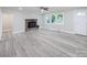 Living room with wood-look flooring, fireplace, and ceiling fan at 5625 Highway 601 Hwy, Salisbury, NC 28147
