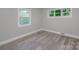Well-lit bedroom featuring wood-look floors and two windows at 5625 Highway 601 Hwy, Salisbury, NC 28147