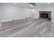 Living room featuring fireplace, vinyl flooring, and access to hall at 5625 Highway 601 Hwy, Salisbury, NC 28147