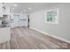 Open concept dining area with wood-look flooring and view into kitchen at 5625 Highway 601 Hwy, Salisbury, NC 28147