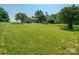 Spacious backyard with lush green grass and mature trees at 5625 Highway 601 Hwy, Salisbury, NC 28147