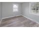 Bedroom with wood-look floors and two windows offering natural light at 5625 Highway 601 Hwy, Salisbury, NC 28147