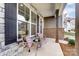 Cozy front porch with wicker chairs, side table, and stone exterior at 102 Ballantree Rd # 70, Mooresville, NC 28115