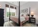 Charming bedroom with a four-poster bed and large windows at 15814 Vale Ridge Dr, Charlotte, NC 28278