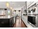 Open concept kitchen with stainless steel appliances and hardwood floors at 15814 Vale Ridge Dr, Charlotte, NC 28278