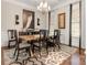 Elegant dining room with hardwood floors, chandelier, and large artwork at 15814 Vale Ridge Dr, Charlotte, NC 28278