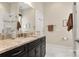 Elegant bathroom with dark vanity, granite countertop, and large shower at 15814 Vale Ridge Dr, Charlotte, NC 28278