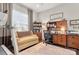 Home office with built-in shelving, desk, and comfortable seating at 15814 Vale Ridge Dr, Charlotte, NC 28278