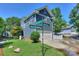 House exterior showcasing blue siding, attached garage, and landscaping at 13950 Cinnabar Pl, Huntersville, NC 28078