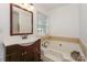 Bathroom with single vanity, soaking tub, and large window at 13950 Cinnabar Pl, Huntersville, NC 28078