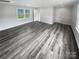 Spacious living room with grey vinyl flooring and white trim at 8819 Richardson King Rd, Waxhaw, NC 28173