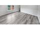 Bright living room featuring grey vinyl flooring and wainscoting at 8819 Richardson King Rd, Waxhaw, NC 28173