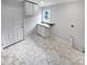 Laundry room with white cabinets and hexagonal marble flooring at 8819 Richardson King Rd, Waxhaw, NC 28173